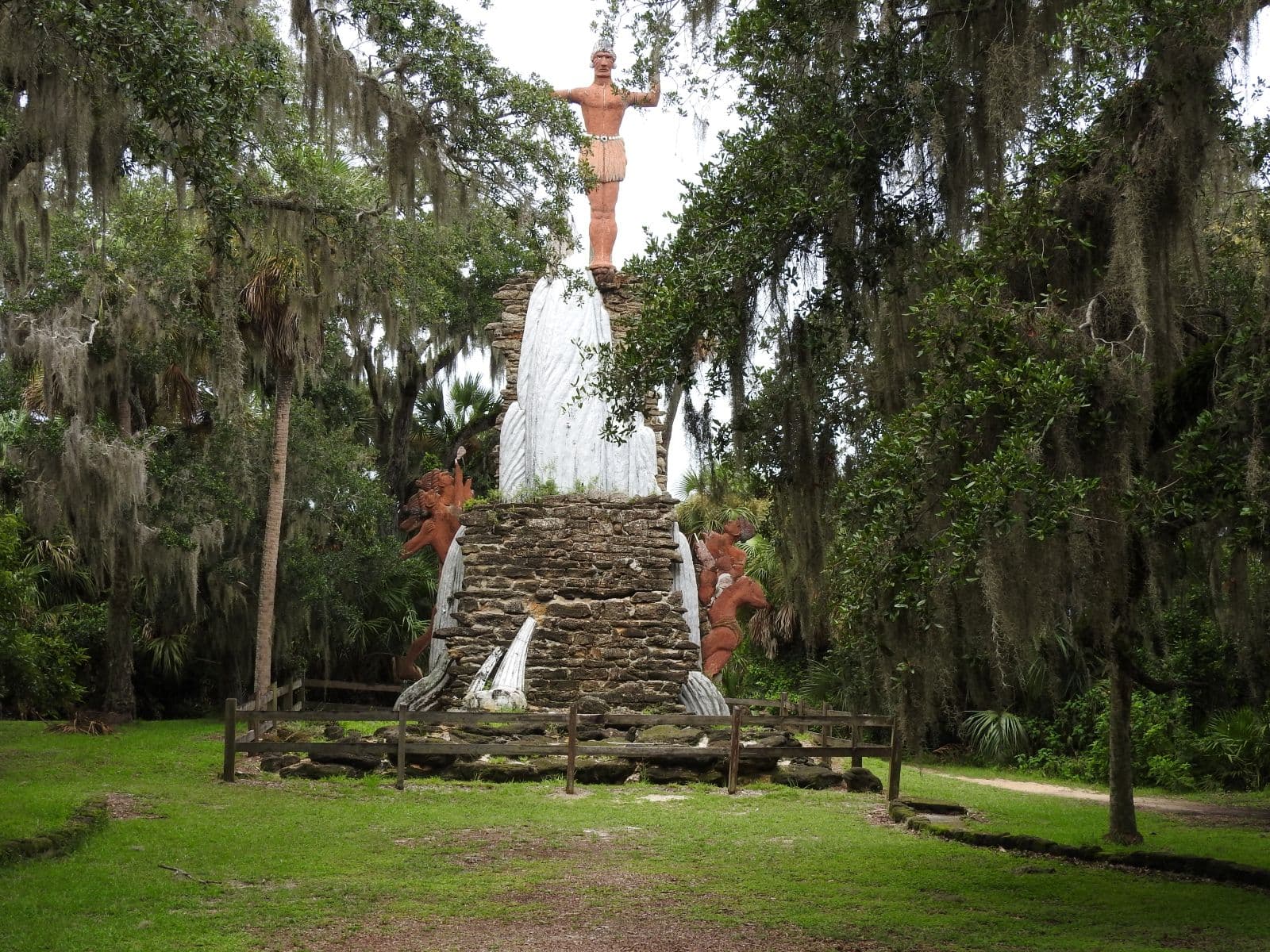 Chief Tomokie monument surrounded by live oaks and hanging Spanish moss.